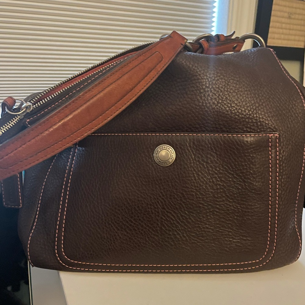 Coach brown leather with pink stitching and lining. Worn twice cute piece.
